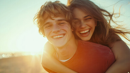 Happy couple enjoying a piggyback ride on the beach during sunset