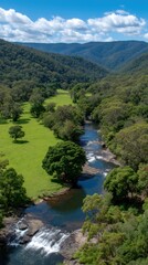 Scenic Valley View Featuring Cascading River, Lush Meadow, Green Forest, and Mountains
