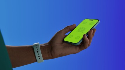 Asian middle aged male using smartphone with a blank green screen. Mobile app video mockup. Vertical phone orientation