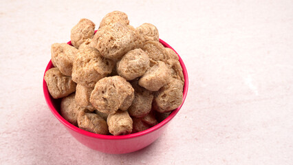 Raw soya chunks on dark background. Healthy, nutritious soybean meat, chunks isolated.Vegan food concept.
