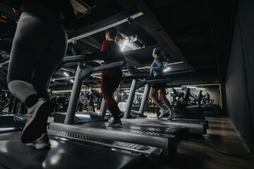 Girls using treadmills in a modern gym environment, emphasizing active lifestyle and fitness. Sleek...