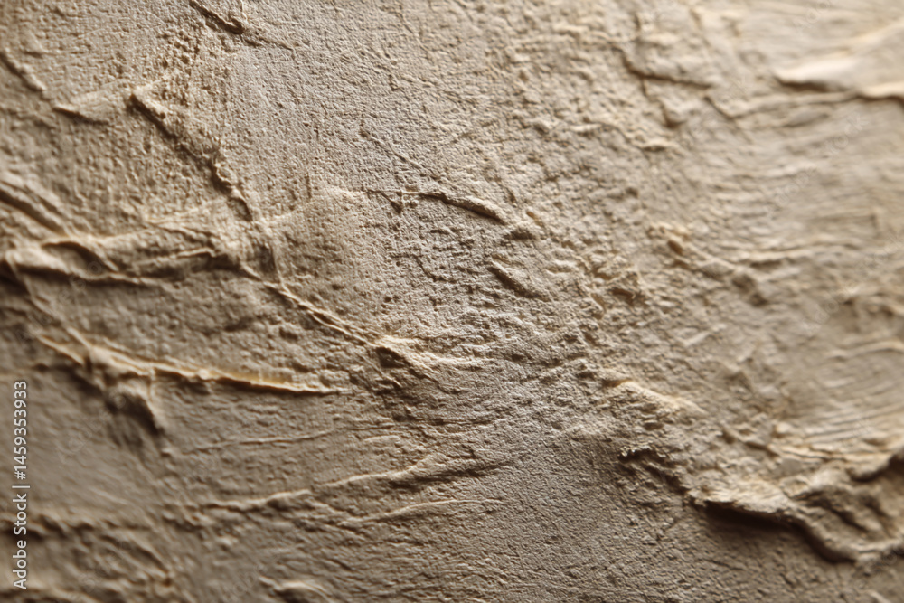 Poster Close-up beige textured surface, showing uneven, rough strokes creating a three-dimensional effect, suitable as a background for design projects