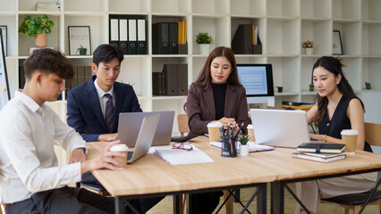 Group of colleagues working on a project with enthusiasm in modern office.