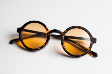 Round glasses with black frames and tortoiseshell lenses on a white background