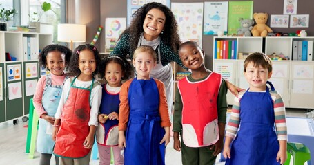 Happy children, portrait and teacher with students at kindergarten school for elementary education. Group, educator or kids with smile for fun learning, creativity or childhood development in class
