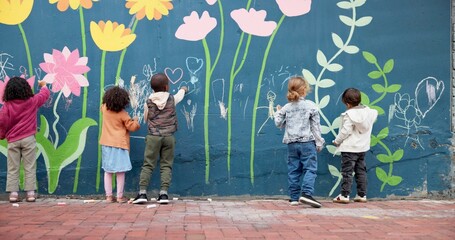 Wall, children and writing with chalk for education, cognitive development and creativity in school. Back, students and kids with learning for drawing mural, inspiration and outdoor in kindergarten