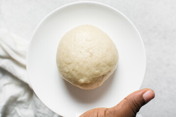 Overhead view of steamed bun on a white plate, top view of mantou on a white background, process of making steamed milk buns