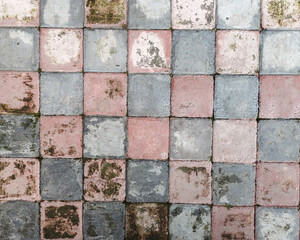 Vibrant mosaic tiles with colorful square tiles in grunge tones. Old antique stone pattern and rough texture, ideal for abstract backgrounds and design projects.