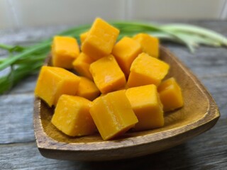 diced cheese lies in a wooden plate