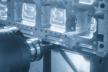 The horizontal CNC milling machine cutting the aluminum parts by solid flat nose end mill tool in the light blue scene.