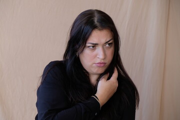 Obraz premium A white woman with dark hair is very upset and will soon cry with resentment