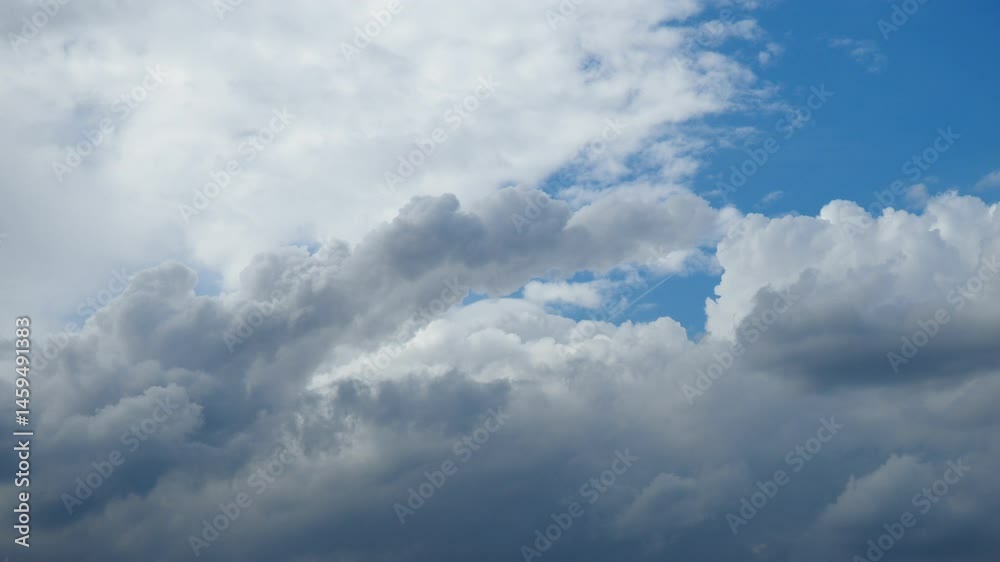 Poster As the sun begins to set, the clouds take on a mesmerizing array of shapes, casting shadows and light across the heavens. This atmospheric display creates a peaceful, awe-inspiring moment in nature