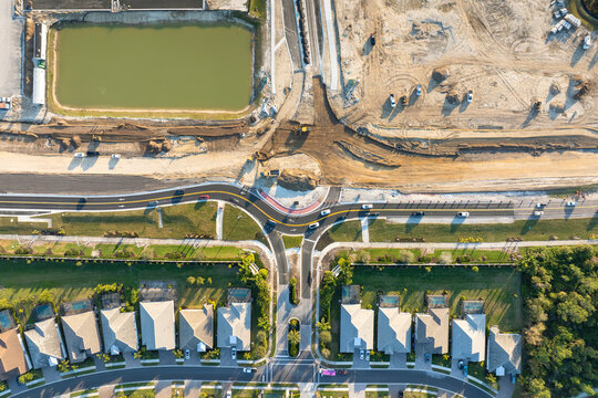 Aerial view of busy American highway road under construction. Development of roundabout traffic infrastructure. State transportation concept