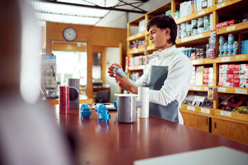 Focused salesman preparing plumbing materials in a hardware store