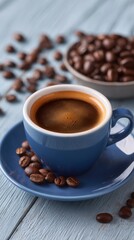 Close-up of an espresso in a blue cup, set on a blue saucer and wooden surface, surrounded by coffee beans and a bowl