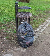 Overflowing rubbish bins in a municipal park.