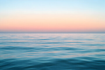 Obraz premium Ocean water under a colorful sky at sunset or sunrise.