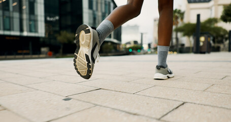 Legs, fitness and sneakers for running in city, concrete floor and movement for cardio workout for...
