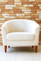 Cream-colored tub chair with wooden legs against a brick wall