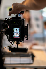 A person is holding a camera with a video recording device