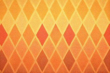 Fototapeta premium Orange Diamond Pattern: A vibrant, textured background featuring a repeating geometric pattern of orange diamonds in varying shades, creating a warm and visually appealing design. 