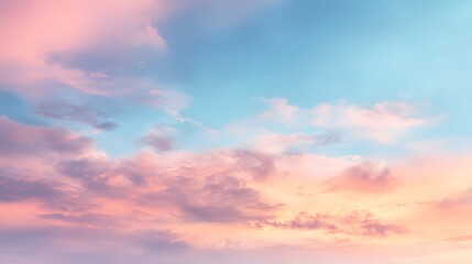 Naklejka premium Tranquil gradient sky with soft peach and rose colored clouds against a serene blue