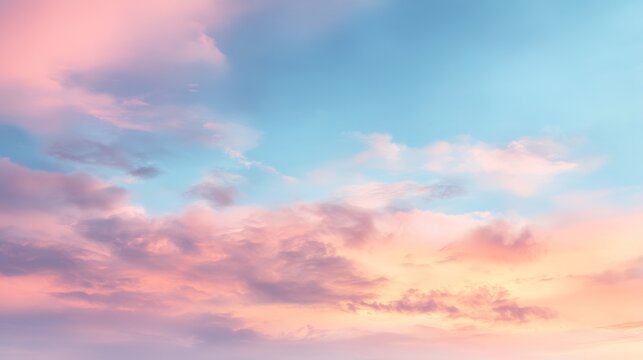 Tranquil gradient sky with soft peach and rose colored clouds against a serene blue