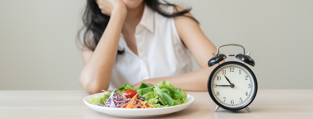 Intermittent Fasting eat concept, Woman looking at meal waiting time to eat during intermittent...