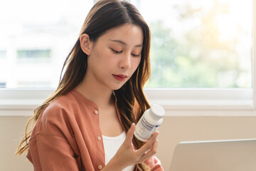 Mindful Health Habits: Engaging in Informed Wellness - A Person Deliberates Supplement Information...