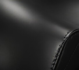 Sleek black leather, fine grain, polished shine , material, gloss