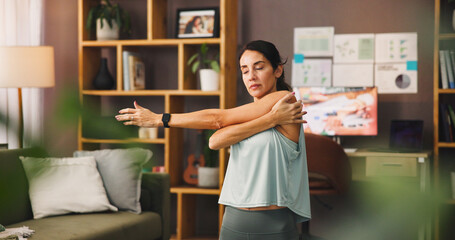 Woman, yoga and stretching with arms for workout, physical exercise or fitness at home. Female...