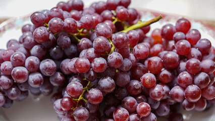 Close up of raw organic sweet red grapes background.