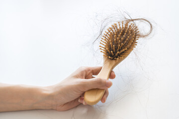 Problem hair, stressed beautiful asian young woman, girl in bathrobe hand holding comb show her...