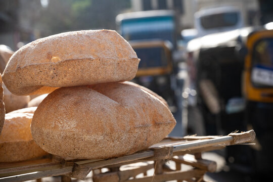 Freshly oven baked traditional Baladi flat bread, for sale in Cairo, similar to pitta bread is a staple of Egyptian cuisine is cooked and sold all over Egypt
