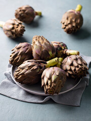 Artichoke hearts on a plate. Grey background. Close up.
