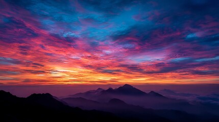 Fototapeta premium Majestic Mountain Range Silhouette Under a Vibrant Multicolored Sunrise Sky