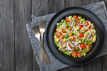 Barley salad with vegetables and walnuts in a bowl