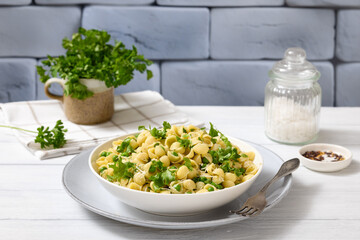 Pasta with green peas in a bowl, italian cuisine