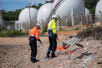 Environmental engineer or workers examining waste water along a  large industrial waste water or...