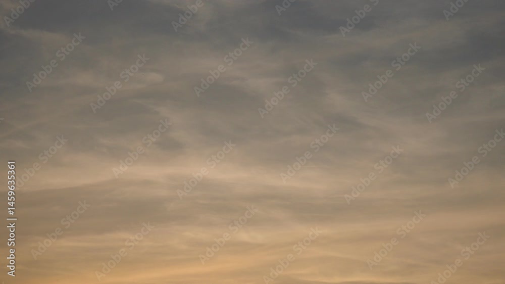 Poster As daylight fades, clouds transform the sky into a canvas of beauty. Shadows and colors meld together, creating a moment of serene reflection. Nature showcases its artistry with every passing moment