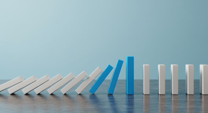 Domino effect shown with blue blocks stopping the fall of white blocks, representing intervention, solution and problem solving concept.