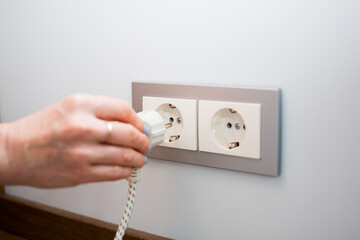 Universal travel adapter in a socket close-up