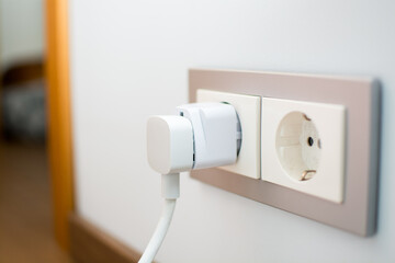 Universal travel adapter in a socket close-up