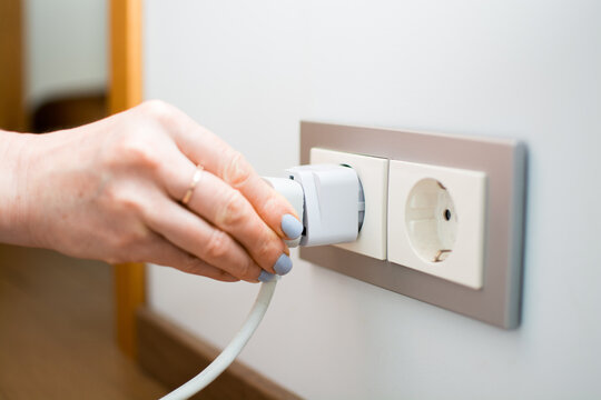 Universal travel adapter in a socket close-up