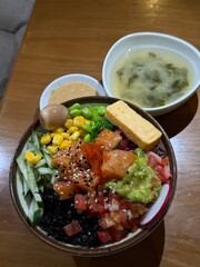 vertical photo Poke bowl soup Wok rice with vegetables. Composition on black background. The Art of Japanese Cuisine. Food photography for menu and sushi bar decoration