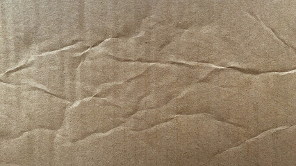 Crumpled brown cardboard texture with wrinkles. Perfect for backgrounds, overlays, graphic design, or editing.