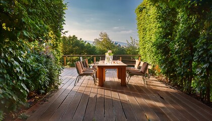 Obraz premium verdant foliage frames a sunny terrace view with drinks on a wooden table