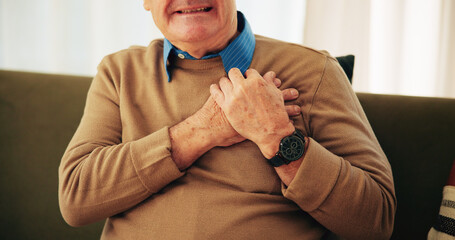 Heart attack, chest pain and hands of senior man on sofa with worry for emergency, medical crisis...