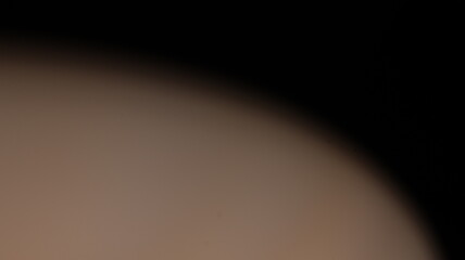 Abstract blurred light with a central warm glow fading into darker edges, creating a soft and...