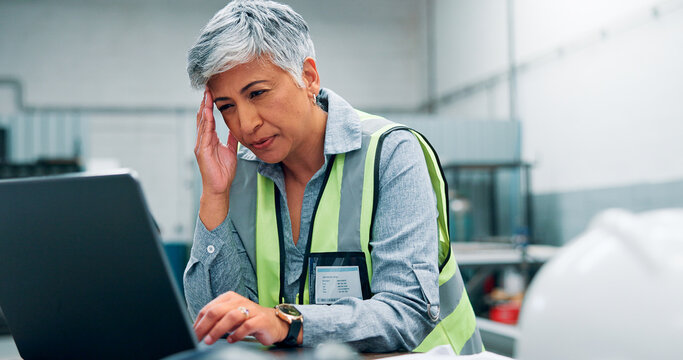 Engineer, laptop and stress with woman in workshop for manufacturing, problem solving or production. Computer, design process and headache with mature employee in factory for tech development